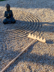 BangBangDa rake in use across outdoor rock garden demonstrating large sweeping meditative lines