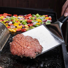 Blackstone closeup of beveled edge highlighting thin precision and benefit: easy sliding under food