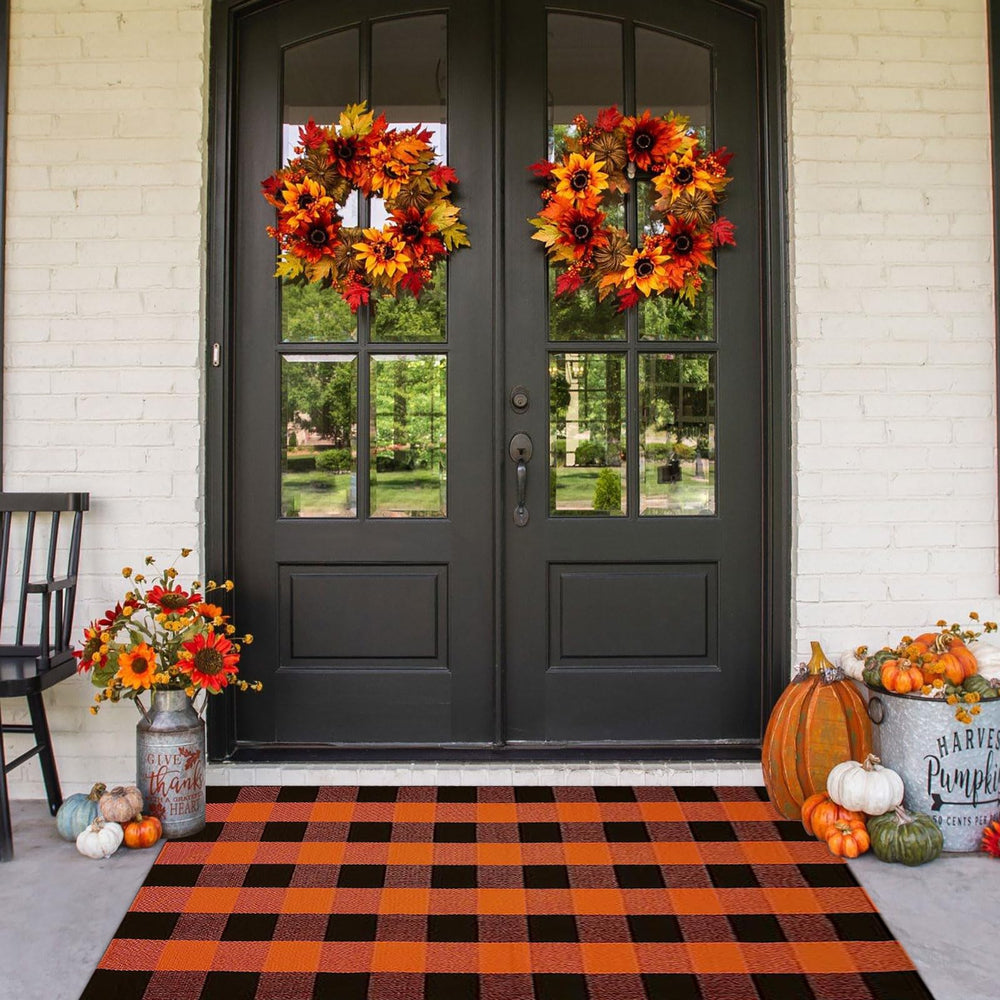 CAINANEL front view orange buffalo plaid rug elevates porch curb appeal