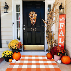 CAINANEL front view orange buffalo plaid rug adding seasonal curb appeal