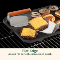 Cuisinart press in use on hot griddle creating caramelized burger crust rapidly