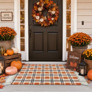 Dunzy front view of orange buffalo plaid rug showing farmhouse welcome