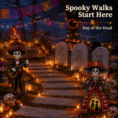 Geelin pair of sugar skull stakes in garden bed creating vibrant Day of the Dead ambiance