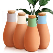 Generic brand front view of four terracotta ollas showing shape and finish, conserves water