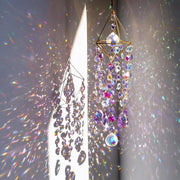 HDCRYSTALGIFTS front view of hanging prism catching sunlight and sparkles