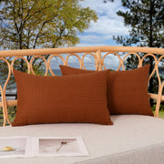 K KEVIN TEXTILE front view showing two burnt orange covers, bright outdoor accent
