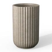 Kante front view of weathered concrete round column planter showing elegant shape and durability