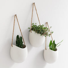 Kazai Ellie front view showing three matte white hanging planters and modern look