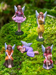 Lamnes figurines inside a glass terrarium creating a tiny landscape scene and inspiring creativity