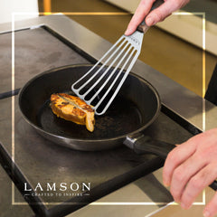 Lamson spatula lifting fish fillet in pan preserving delicate texture