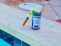 Leakmaster dye being applied near pool return, helps reveal leak by following flow