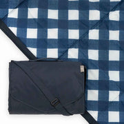 Little Unicorn navy plaid blanket folded showing compact carry and travel convenience