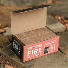 Masterbuilt cubes placed on charcoal illustrating fast ignition