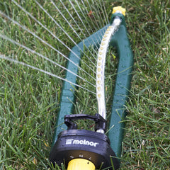 Melnor sprinkler placed on lawn showing rectangular coverage benefit