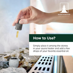 Northwood Sauna cup placed among heater stones demonstrating safe placement and gentle diffusion
