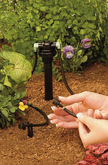 Orbit manifold installed on PVC riser delivering water to four drip lines in planting bed