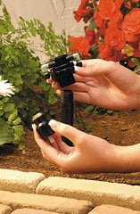 Orbit manifold next to a ruler showing compact size and scale for tight irrigation spaces