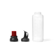 OXO clear basting bottle front view with neat pouring benefit