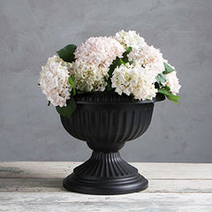 Root & Vessel urn on patio with plants illustrating outdoor styling and UV-resistant benefit