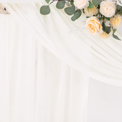 Socomi drape installed on wedding arch creating airy romantic backdrop