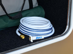 Teknor Apex NeverKink hose connected to RV spigot offering reliable potable water supply