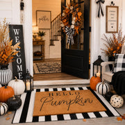 Tinideya front porch styled with mats and pumpkins for warm curb appeal