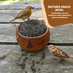 TRAILMARK NATURALS being scattered by hand to feed ground-feeding birds efficiently