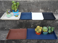 VUWEZ trays holding potted plants on a windowsill showing tidy water containment