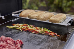 Weber warming rack holding toasted buns on griddle showing even warming benefit