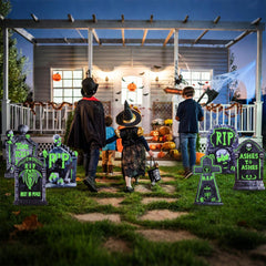 WruFiz tombstones glowing in dark yard to create spooky nighttime ambiance