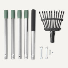 Amazon Basics rake in garden use clearing leaves near shrubs for neat landscaping
