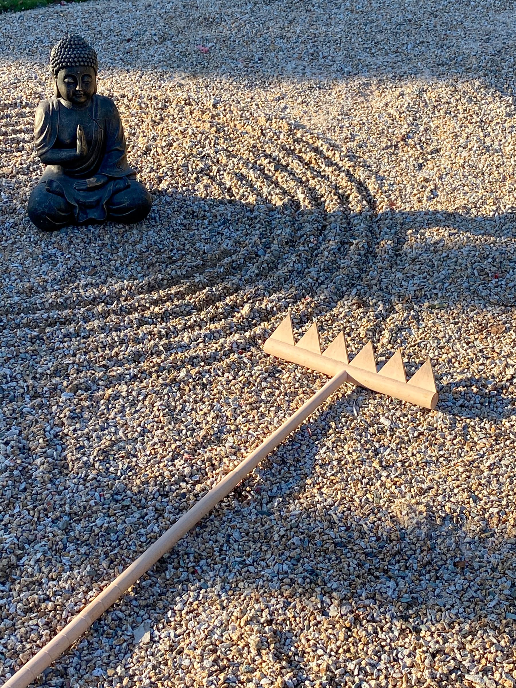 BangBangDa rake in use across outdoor rock garden demonstrating large sweeping meditative lines