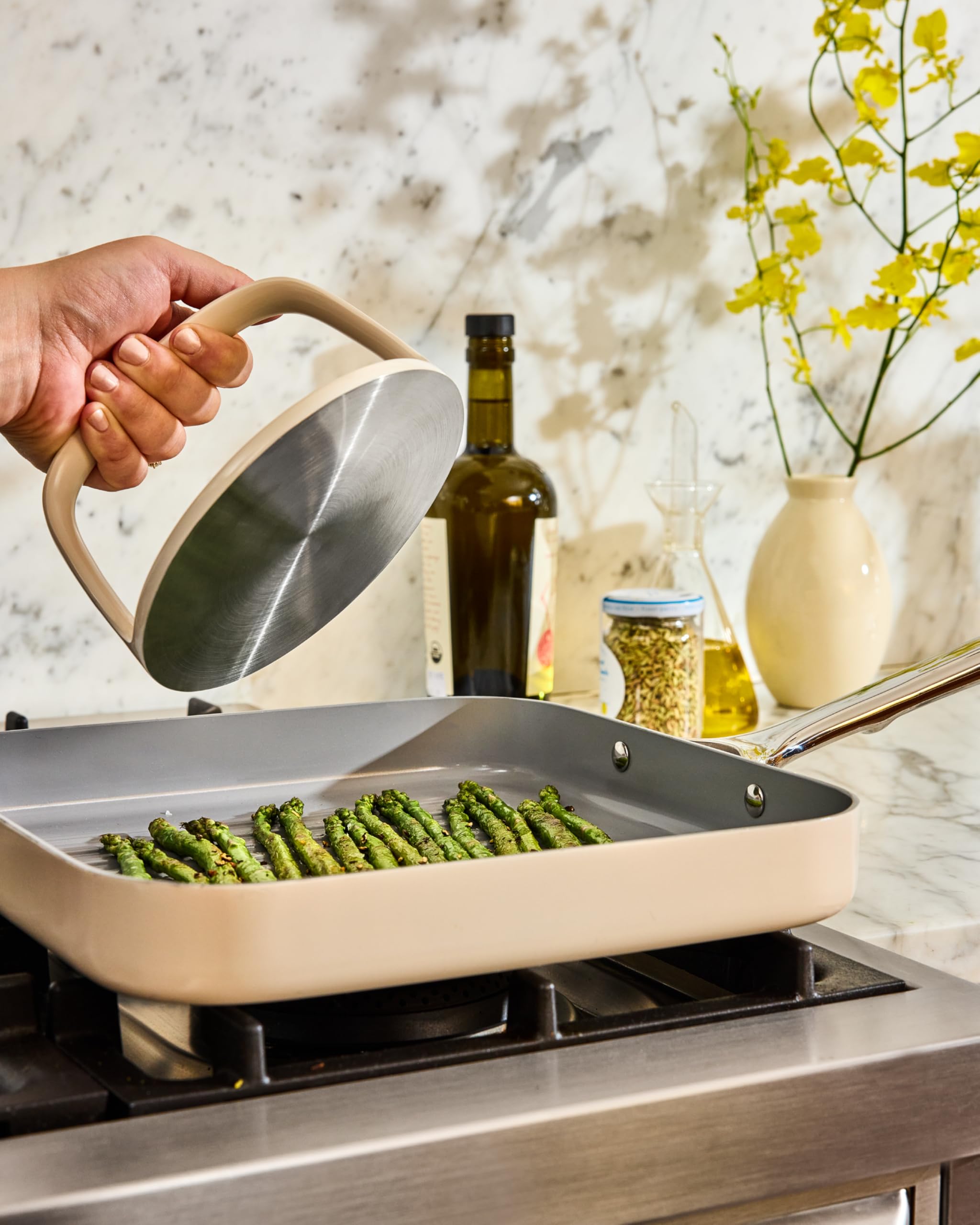 Caraway grill press in recycled packaging showing sustainable production and care