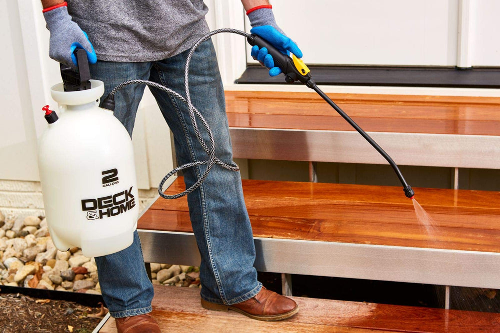 Deck & Home sprayer next to garden hose showing 2-gallon size advantage