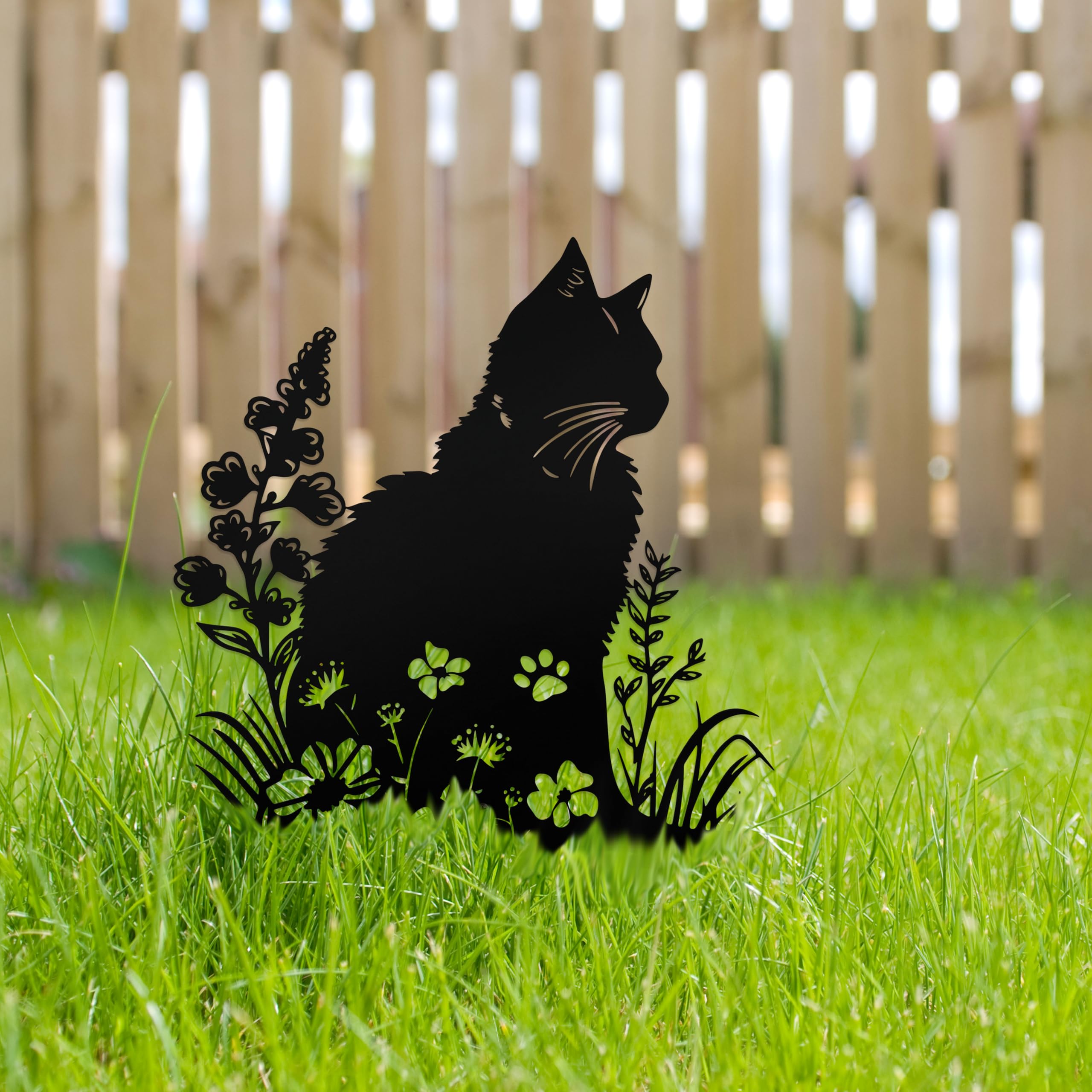 dryelves cat placed in flowerbed illustrating decorative memorial in landscape