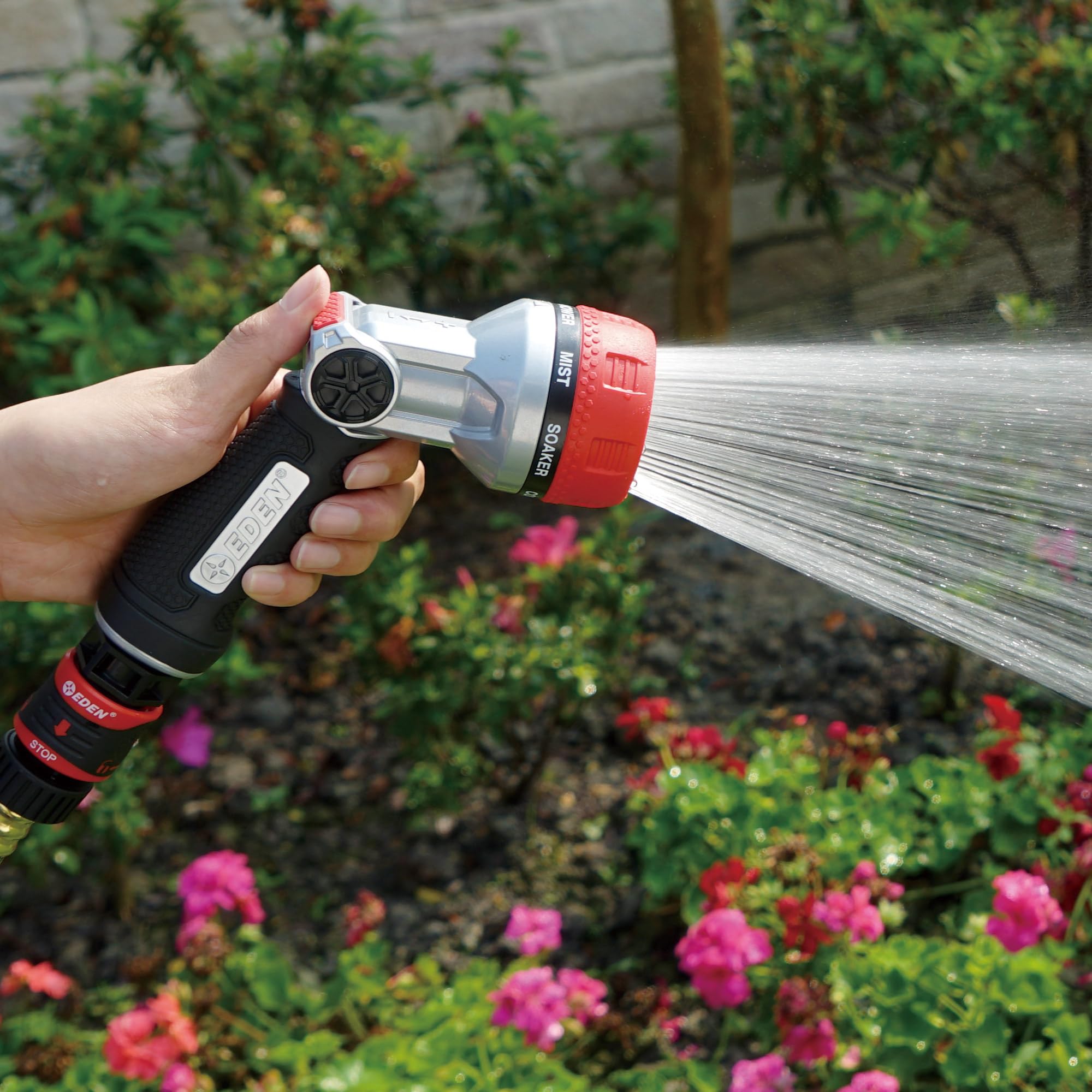 Eden nozzle watering potted plants demonstrating versatile spray patterns benefit