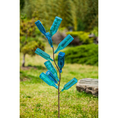 Evergreen Family Products staked bottle tree in garden showing easy installation and stability