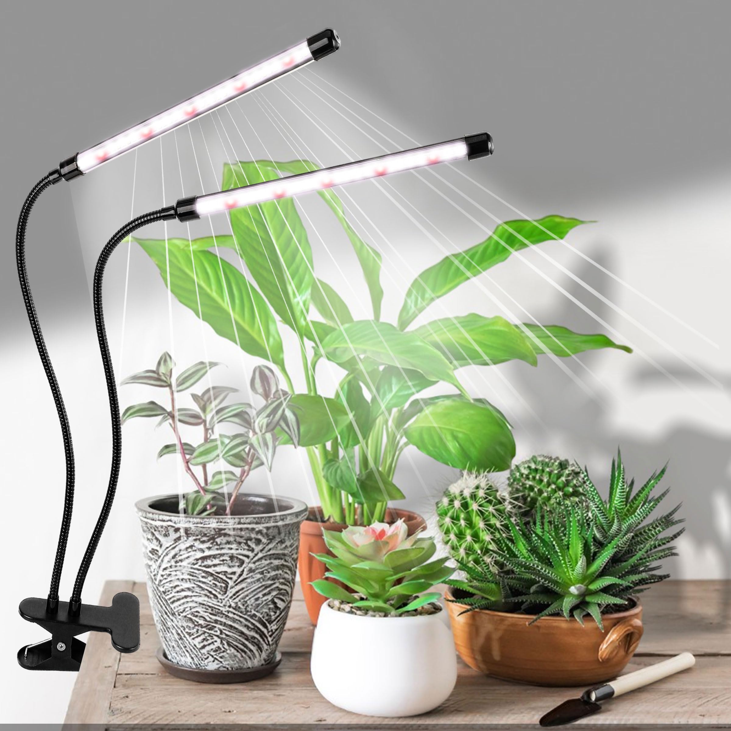 EWPJDK grow light illuminating three potted herbs on a windowsill