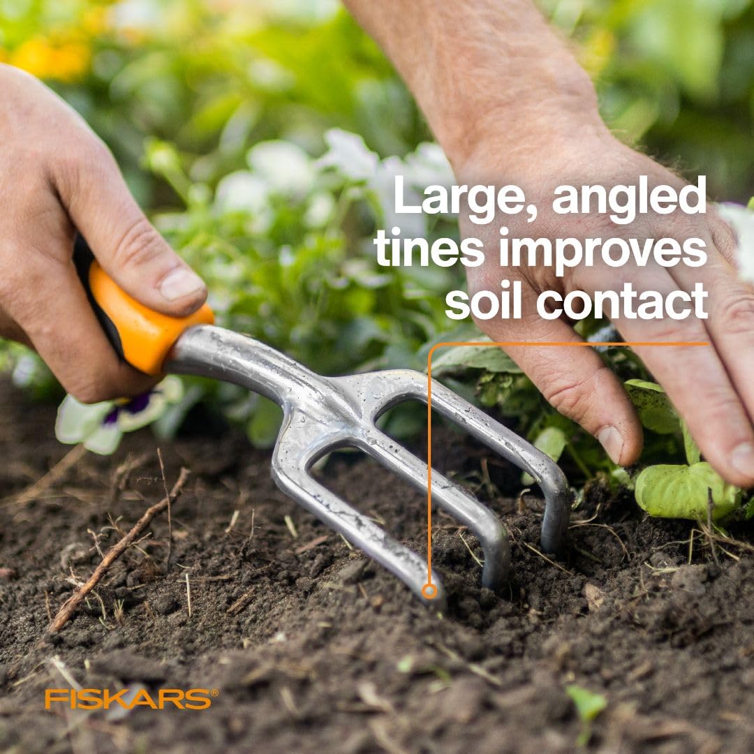 Fiskars beside a gloved hand to show compact size and maneuverability