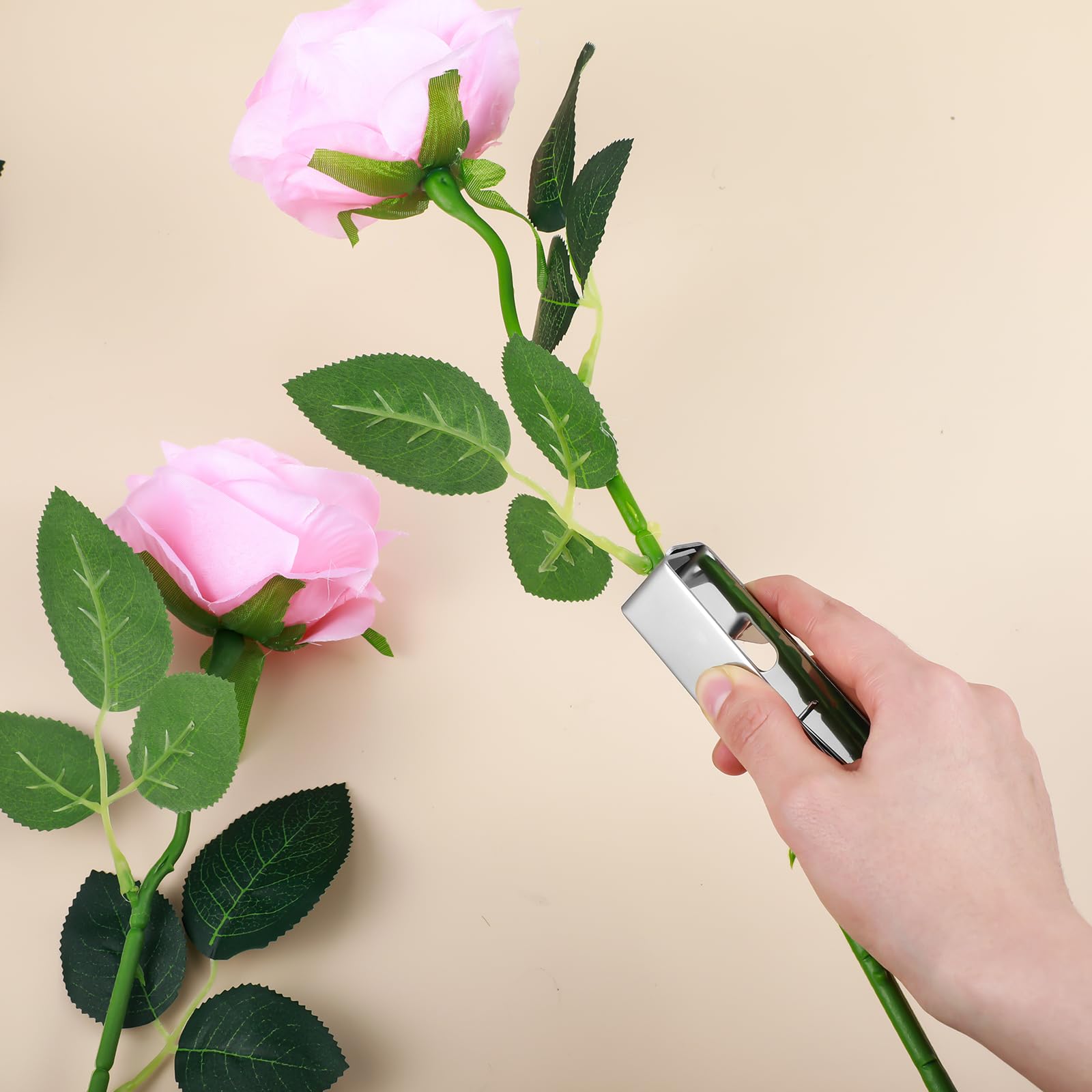 Gisafai removing thorns from a rose stem for safer handling