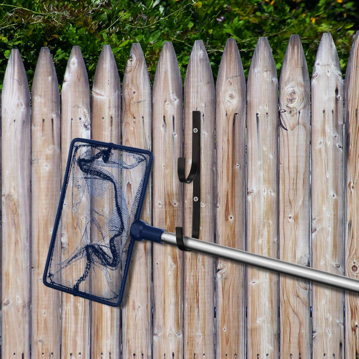 Hotop holding pool poles and brushes showing tidy off-ground storage benefit