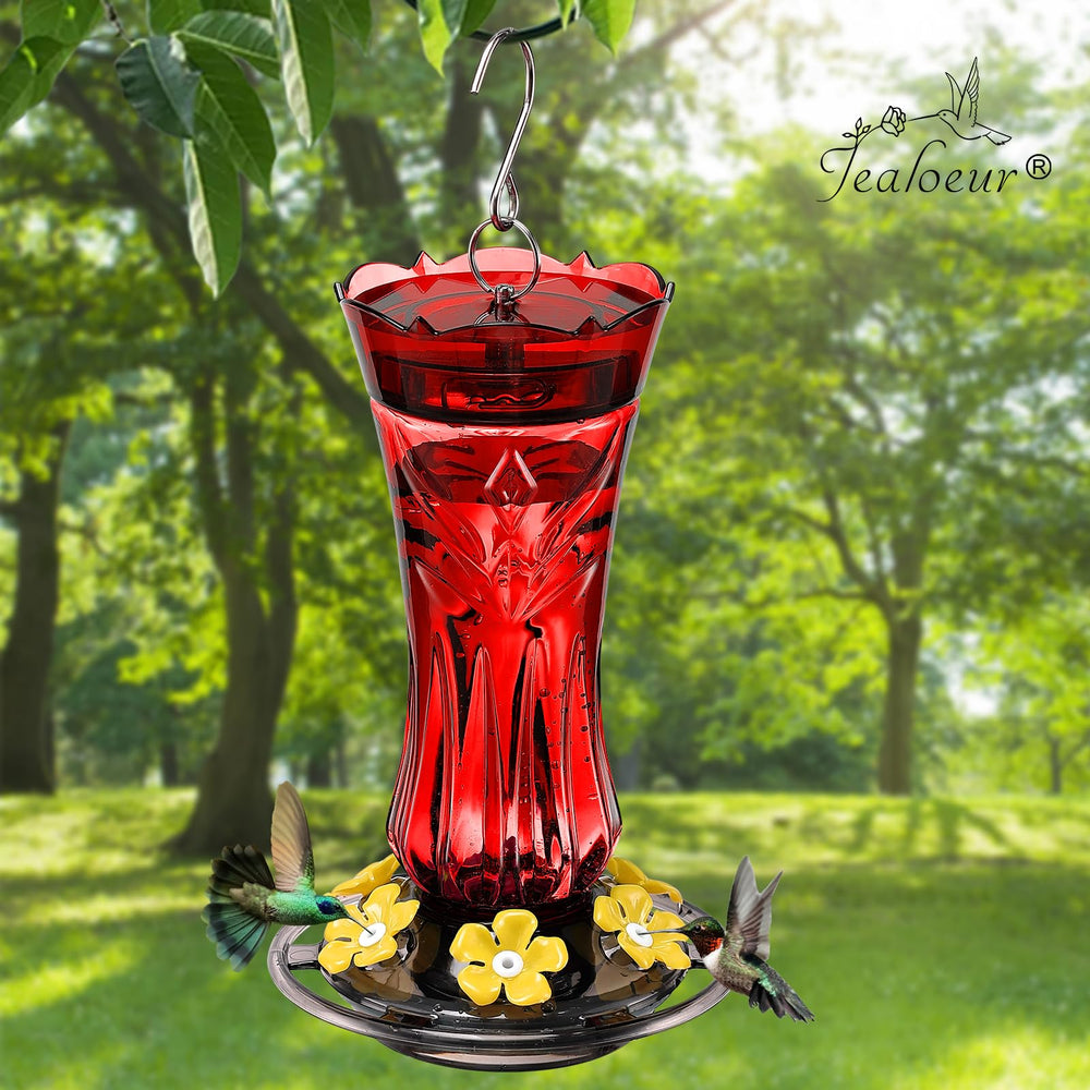 Jealoeur feeder with hummingbird feeding, demonstrating easy access and natural behavior