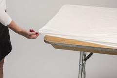 Kwik-Covers on an outdoor event table, tidy surface and wind-resistant benefit