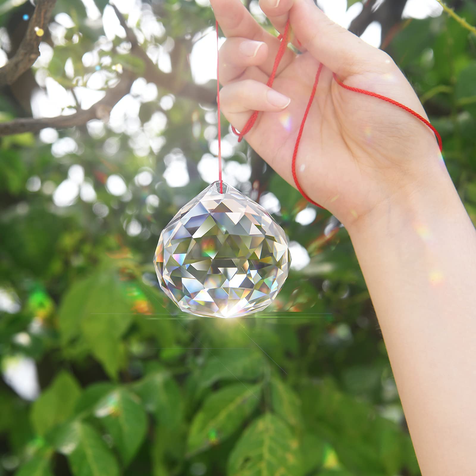 MerryNine suspended from car mirror producing colorful reflections and visual charm