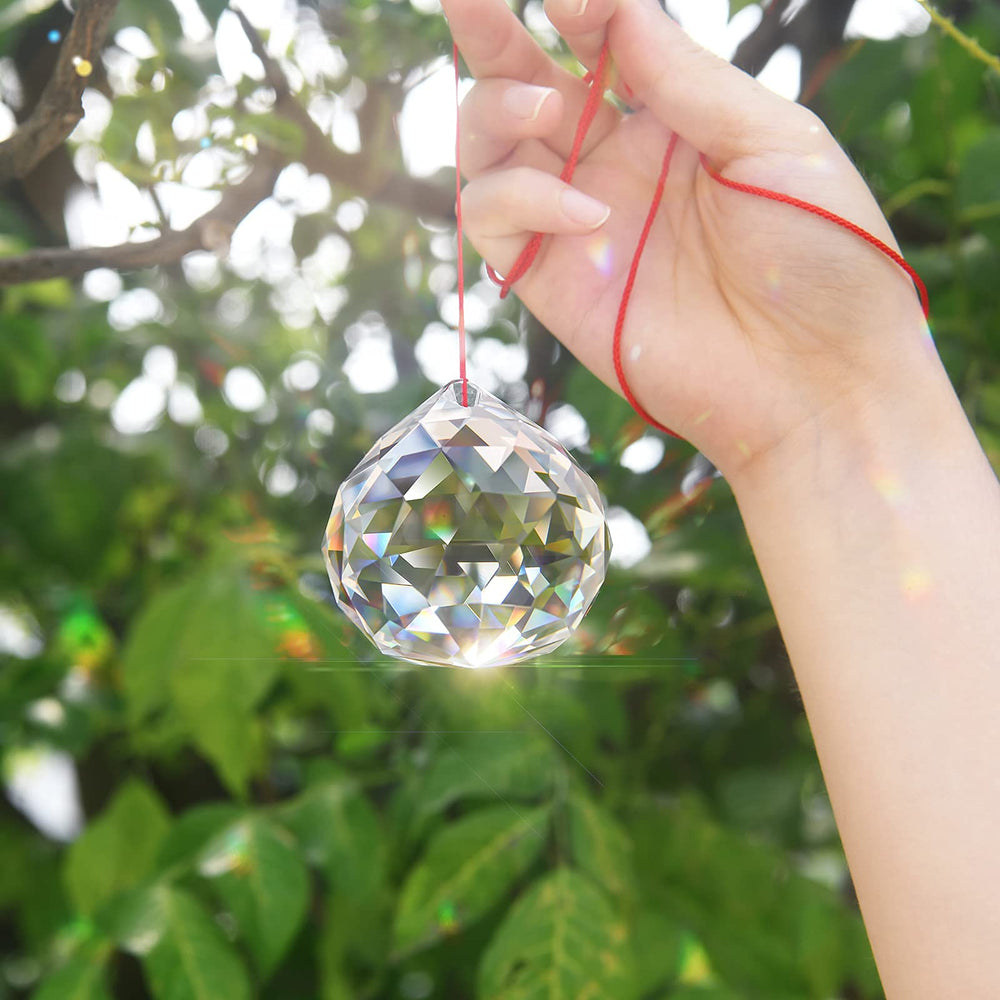 MerryNine suspended from car mirror producing colorful reflections and visual charm