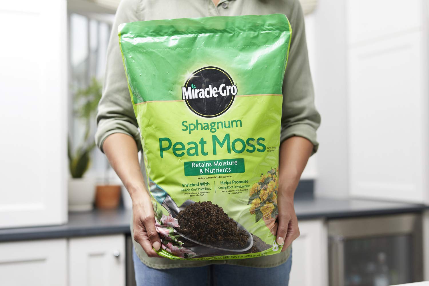 Miracle-Gro bag being mixed into garden soil to improve drainage and aeration