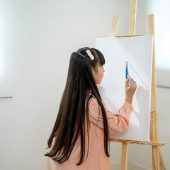 Newflager hand holding board to show 18 by 24 inch scale and portability