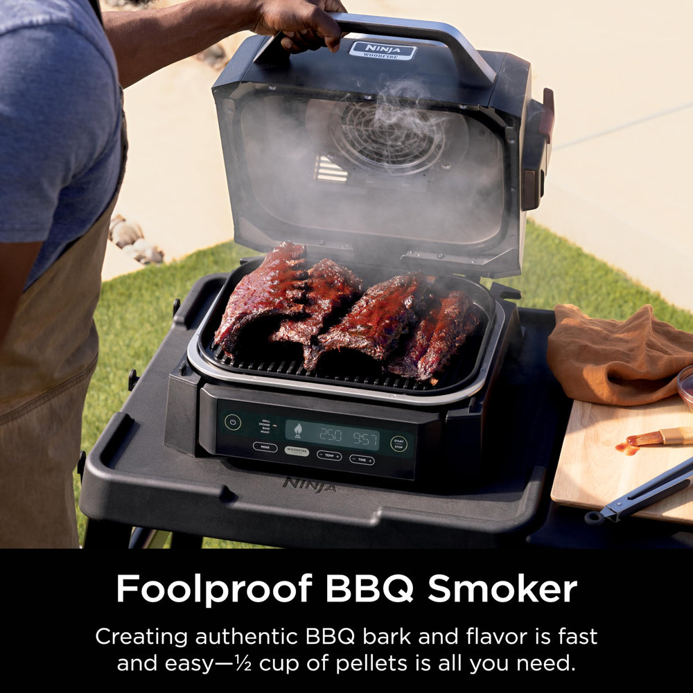 Ninja woodfire size comparison with person illustrating small-footprint outdoor capacity