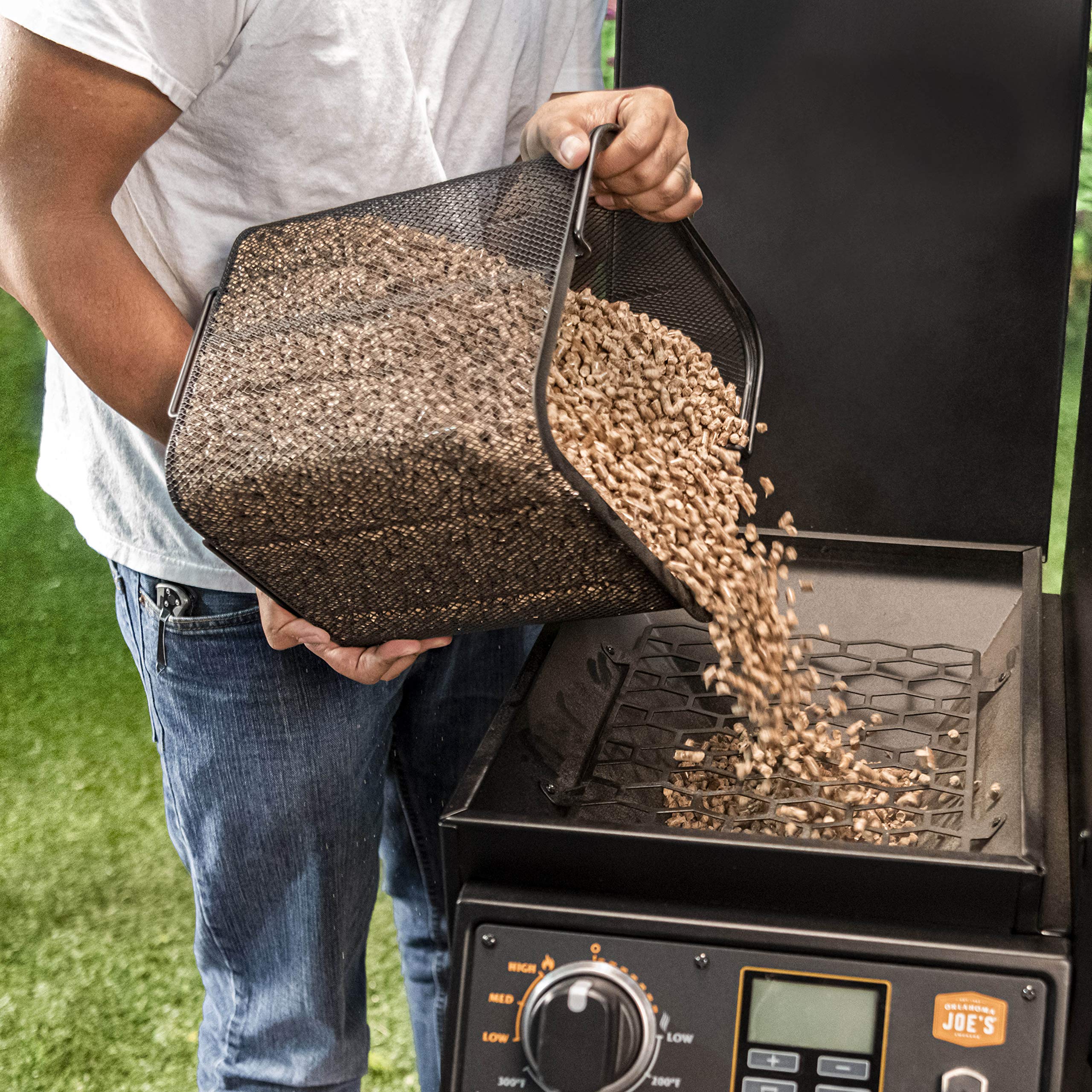 Oklahoma Joe's heavy-duty scoop transferring pellets into a grill hopper for fast loading