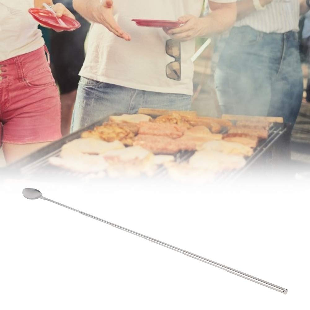 ORULA spoon in use at a barbecue keeping hands away from heat and flames
